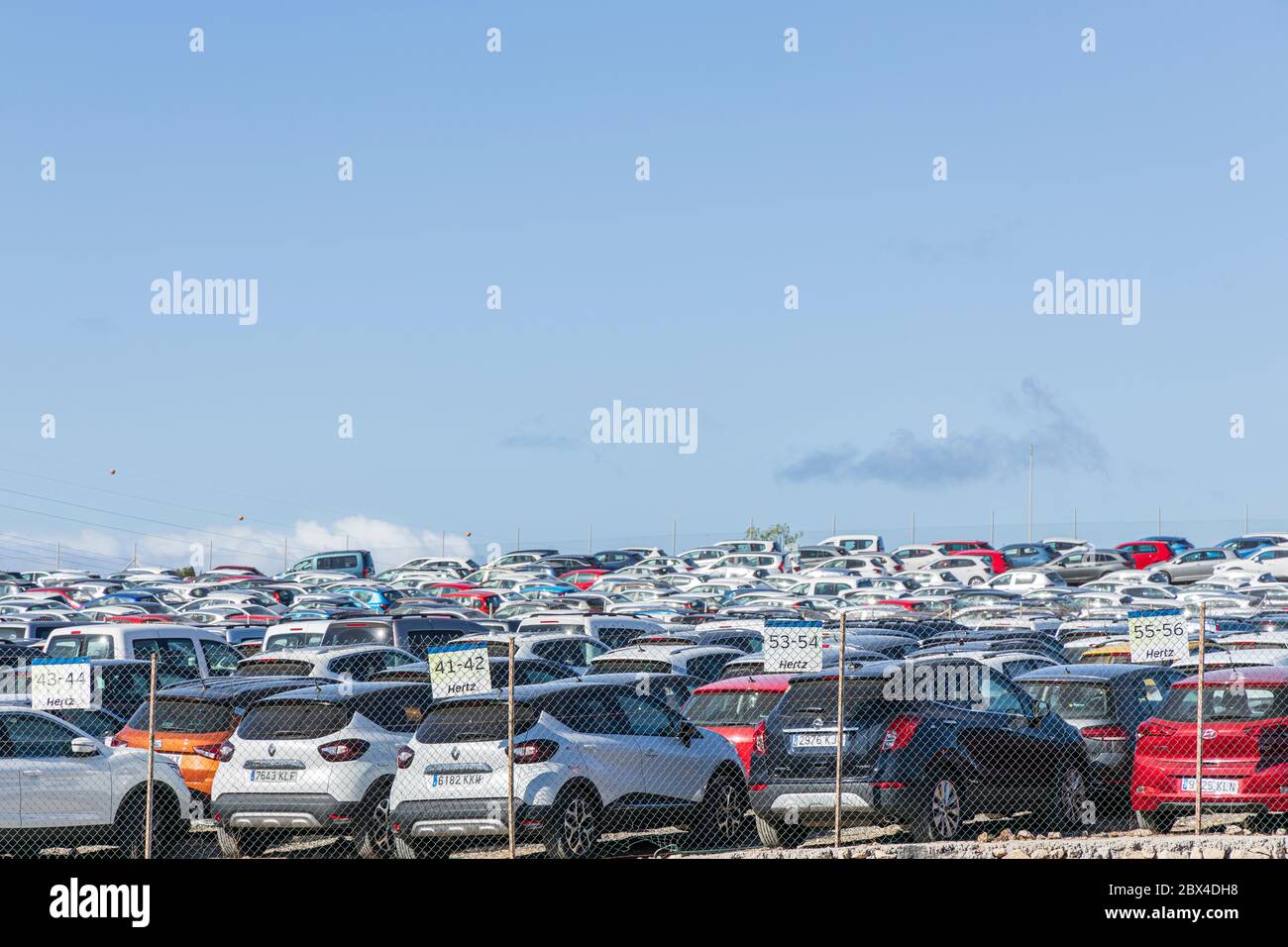 Thousands of unused hire cars are parked up in temporary storage due to the effects of zero tourism and no holidaymakers coming to the island. The ren Stock Photo