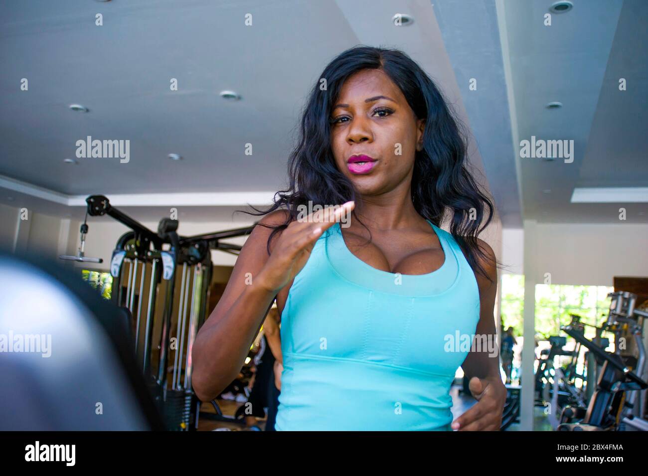 Fit Young Woman Sweating during a Gym Workout with Rings Stock