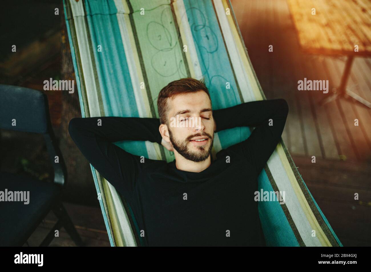 Mid adult man lying in hammock hi-res stock photography and images - Alamy