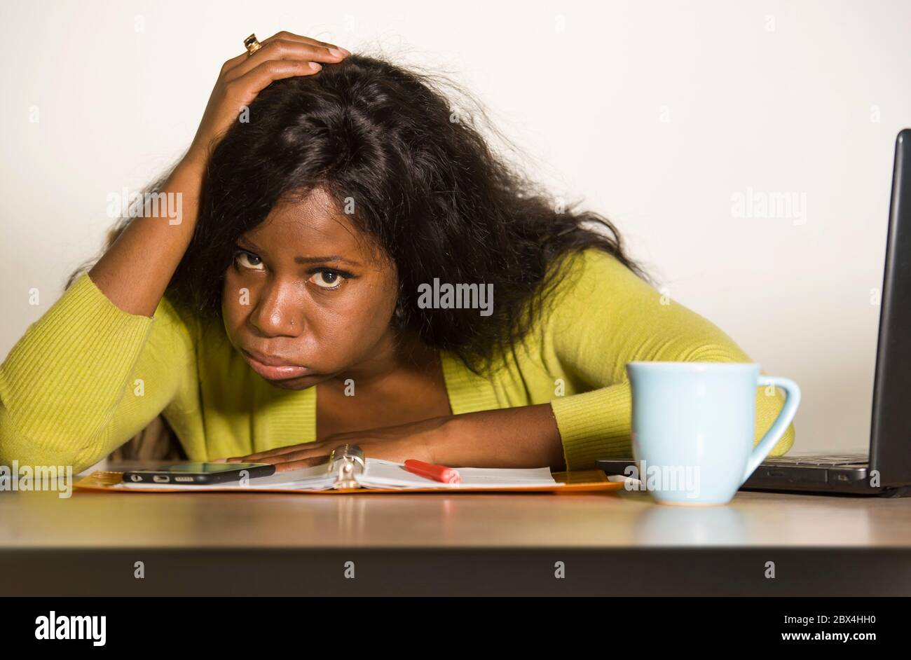 young attractive unhappy and exhausted black African American woman working lazy on Monday at office computer desk feeling overwhelmed bored and frust Stock Photo