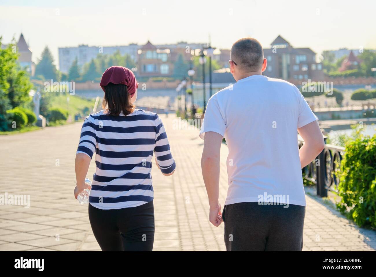 Couple running in city back view, mature man and woman together Stock Photo