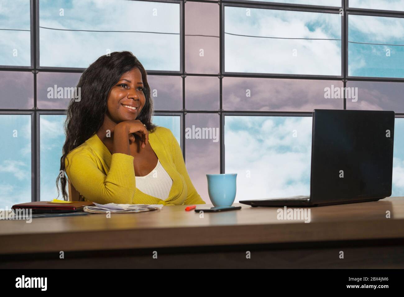 young happy and attractive black afro American business woman smiling