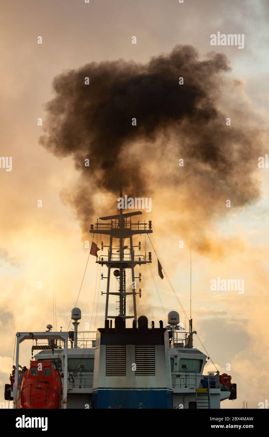 Las Palmas, Gran Canaria, Canary Islands, Spain. 5th June, 2020.  A fuel tanker belches out black smoke as it arrives in Las Palmas port on Gran Canaria at sunrise. Credit: Alan Dawson/Alamy Live News Stock Photo