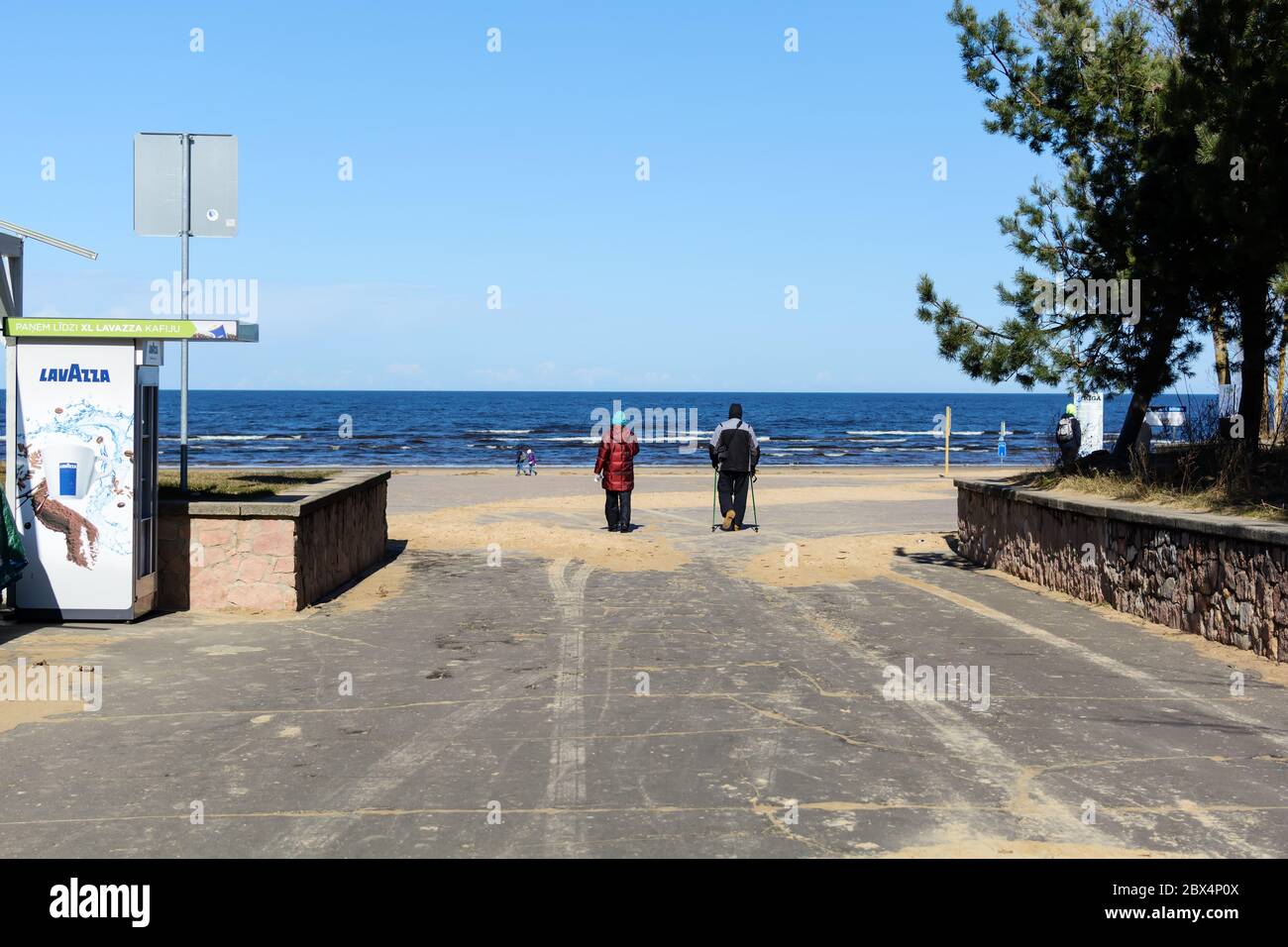 Man on crutches going to the sea with a woman Stock Photo