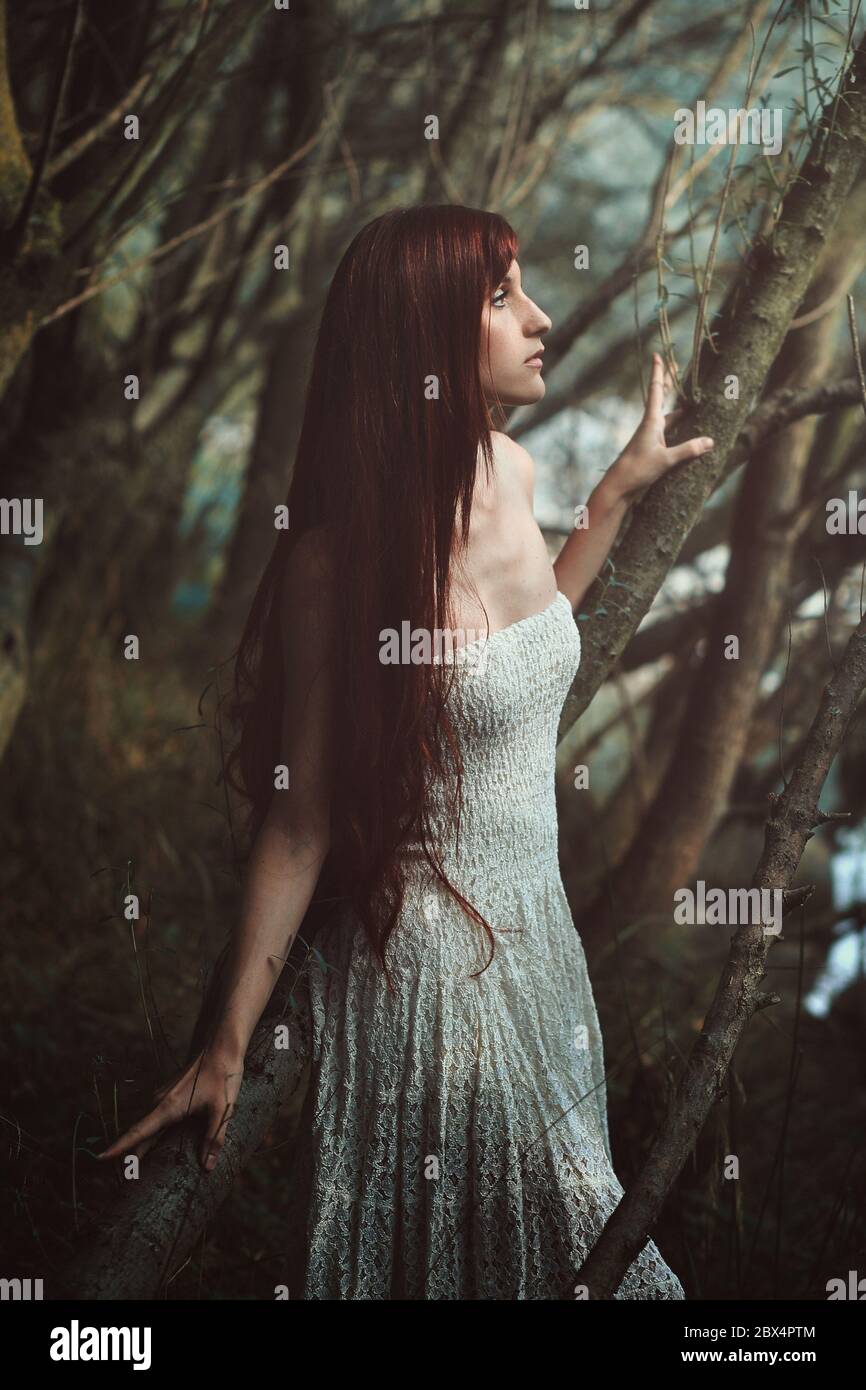 Red hair woman in the woods . Fine art portrait Stock Photo