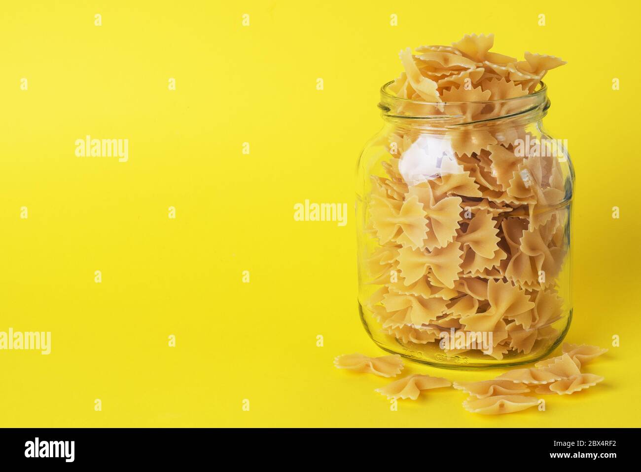 Dry pasta in a glass jar. Copy space. Concept of food storage, donations Stock Photo