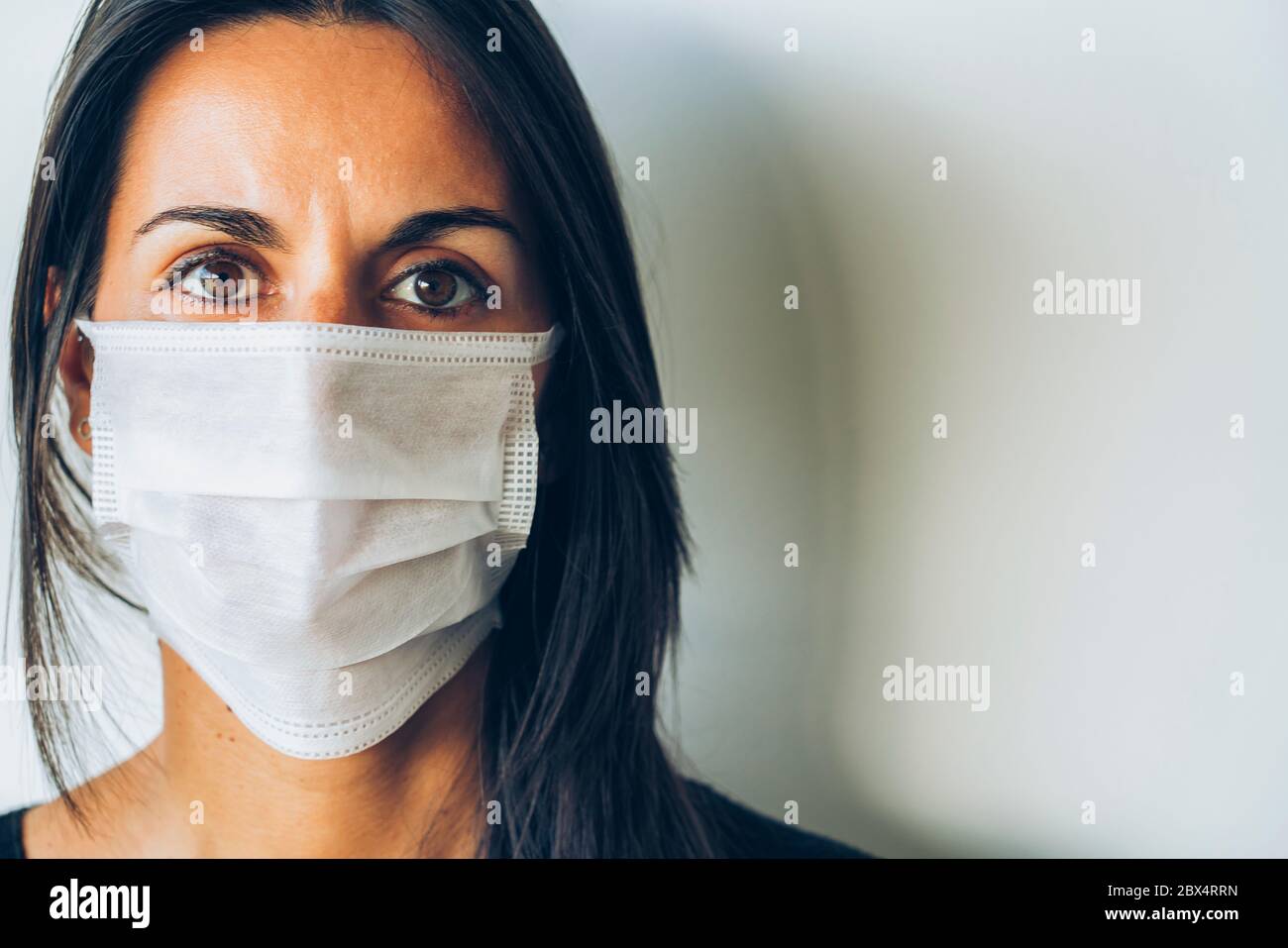 Woman wearing a face protective mask during COVID19 virus Stock Photo