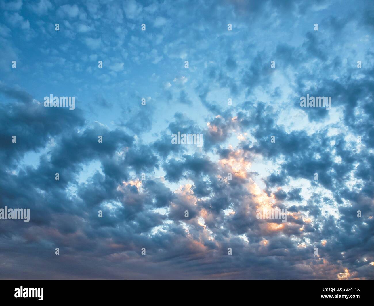Impressive cloudy multicolored sunset sky field background,pattern wallpaper Stock Photo