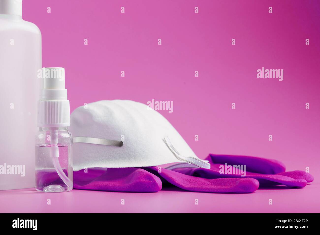 Anti-virus protection kit on a pink background, mask, rubber gloves ...