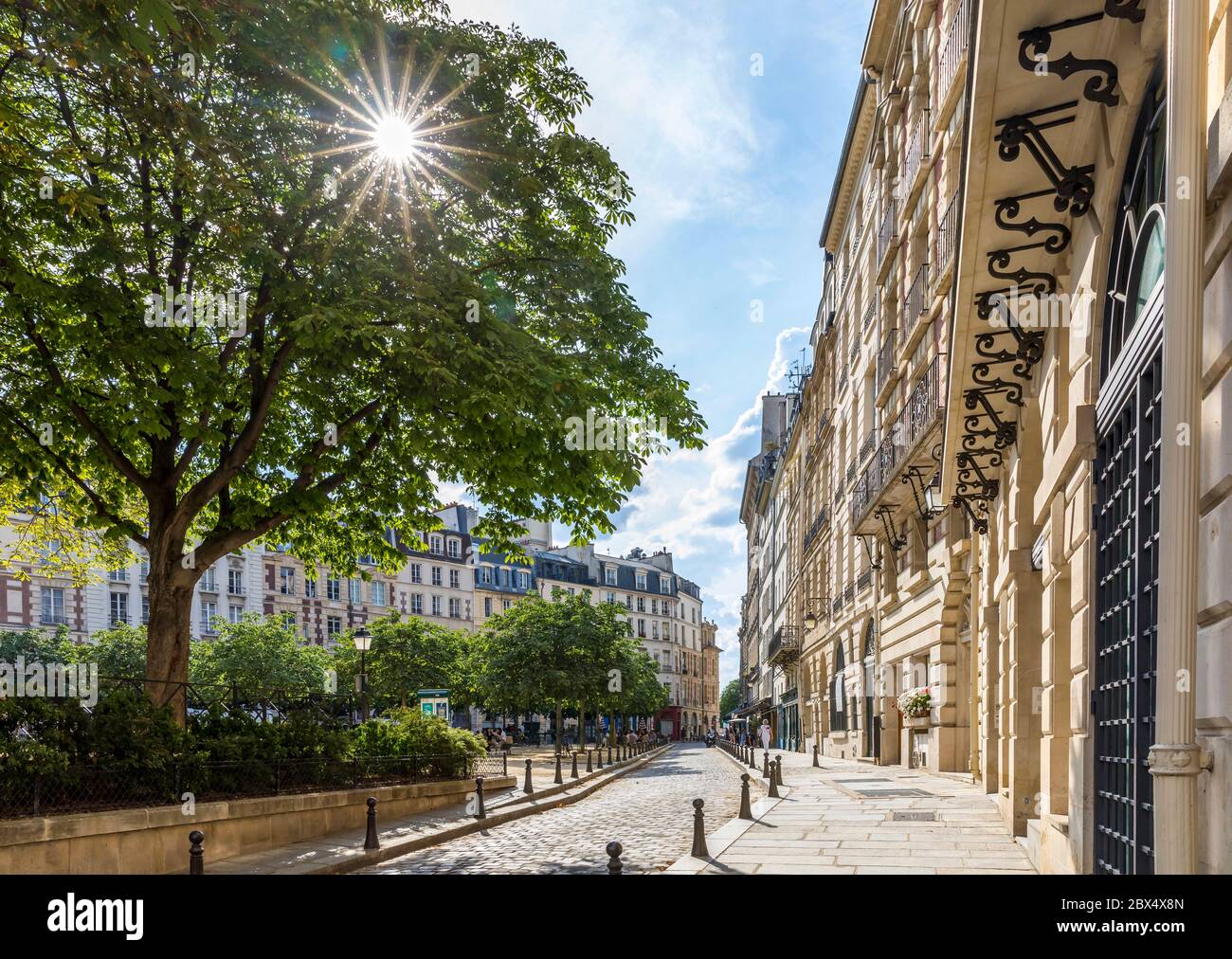 Paris, France - June 3, 2020: People eat again on the terrace of the restaurants after the end of lockdown. Place Dauphine in Paris, France Stock Photo