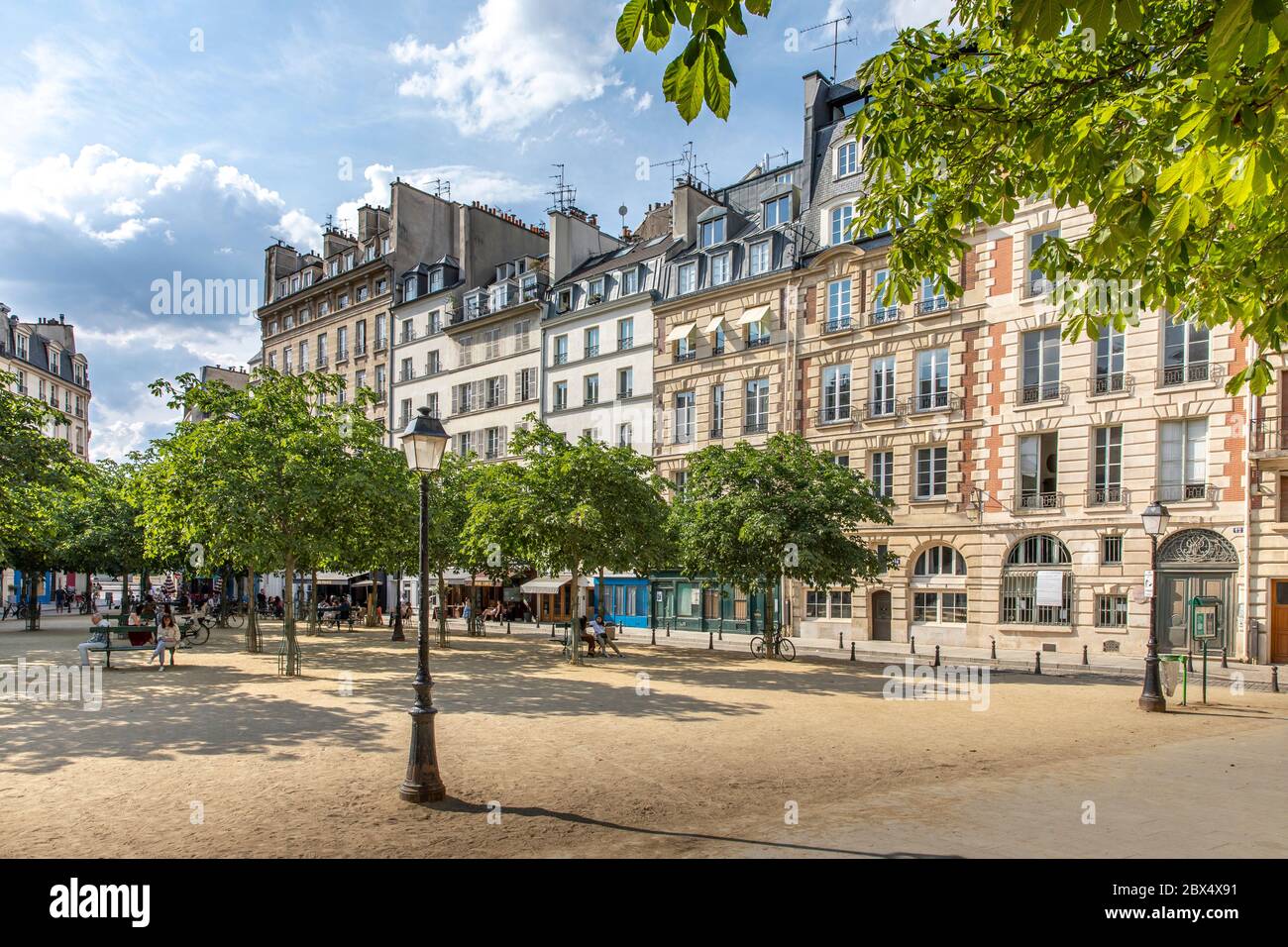 Paris, France - June 3, 2020: People eat again on the terrace of the restaurants after the end of lockdown. Place Dauphine in Paris, France Stock Photo