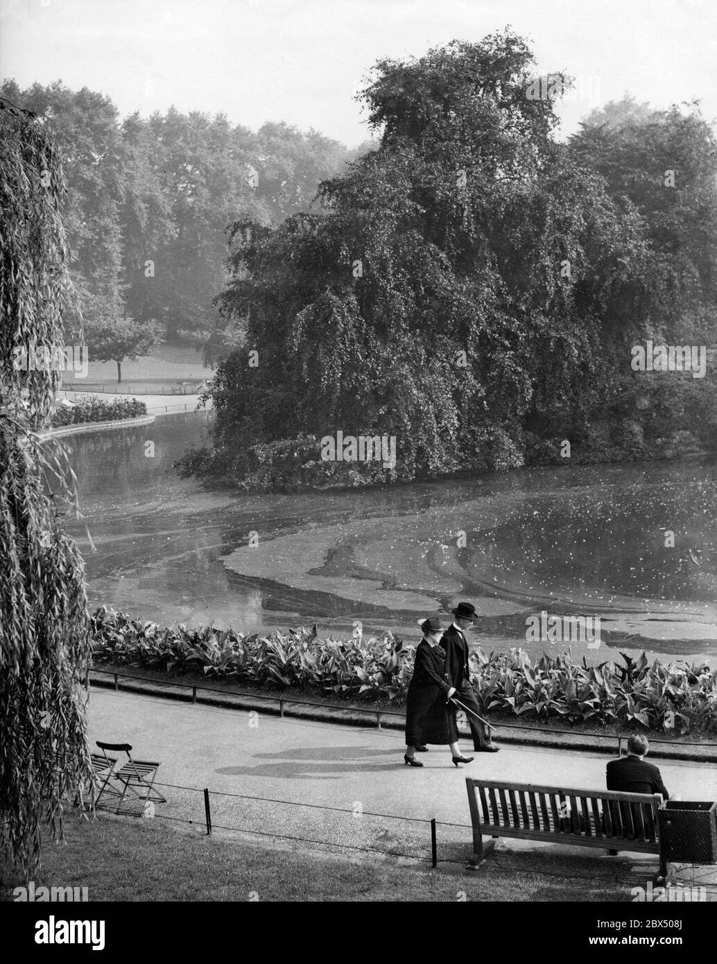 British Prime Minister Neville Chamberlain with his wife during a walk in St James Park in London before a speech in the Parliament on the crisis in European politics. Stock Photo