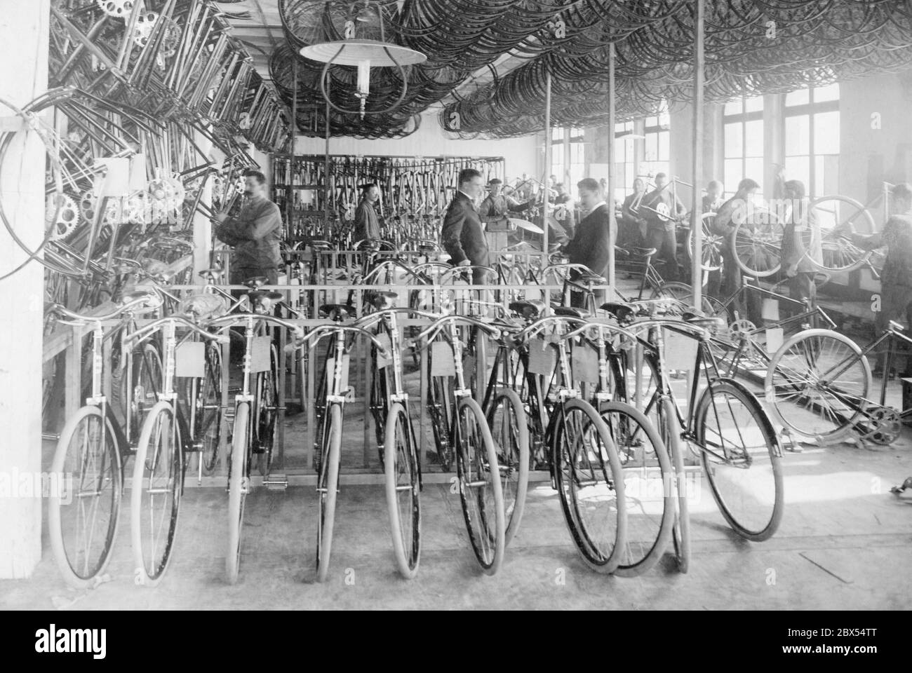 Assembly room of a bicycle factory. Undated photograph, ca. 1900. Stock Photo