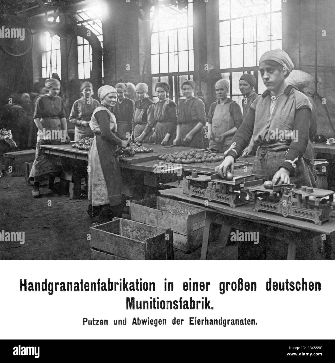 Production of hand grenades in a large German ammunition factory. Workers cleaning and weighing the egg hand grenades. Stock Photo