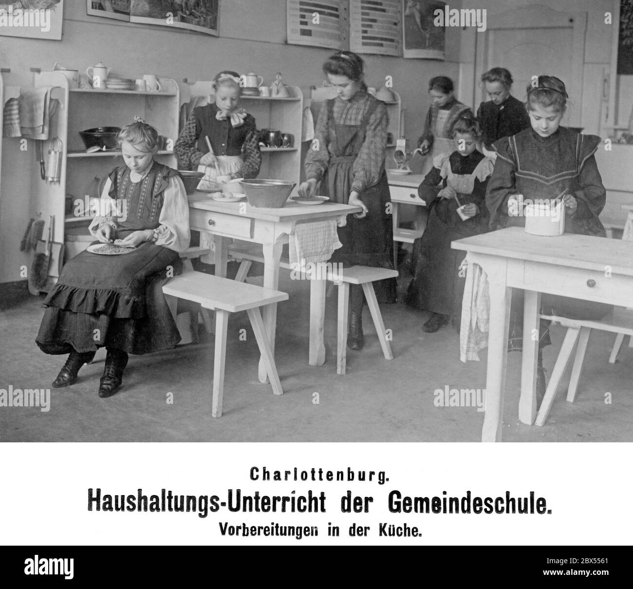 Young girls in a training kitchen preparing kitchen work in the