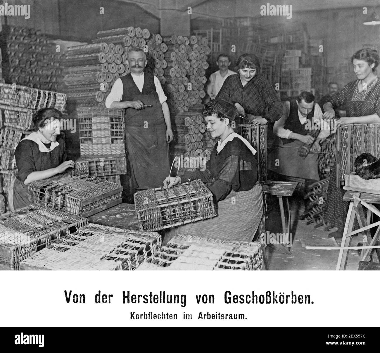 Women weaving baskets in the workshop of a munitions company. Stock Photo