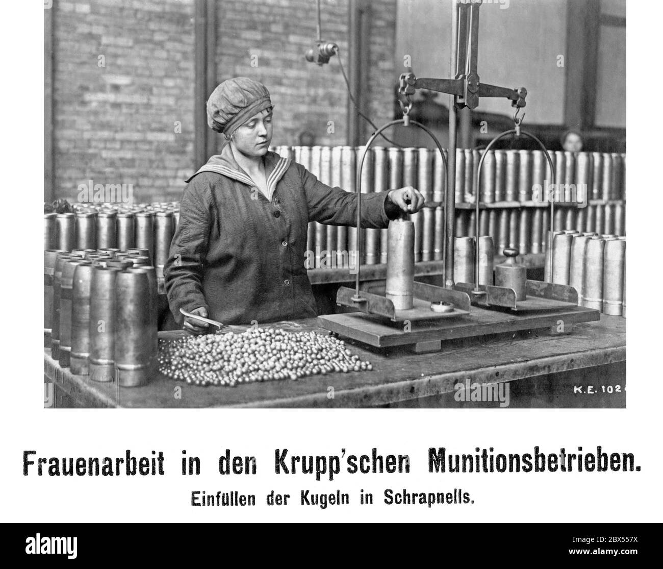 A woman in World War I filling shrapnels with bullets. Stock Photo