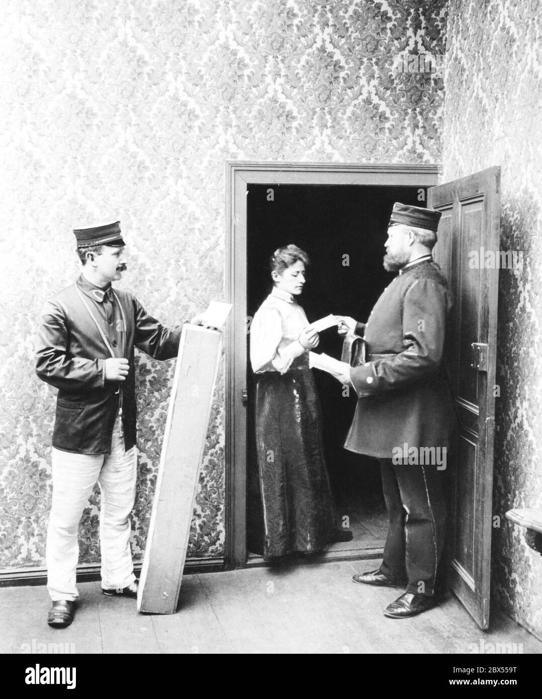 Berlin postmen of the Reichspost delivering letters and parcels in 1897. Stock Photo