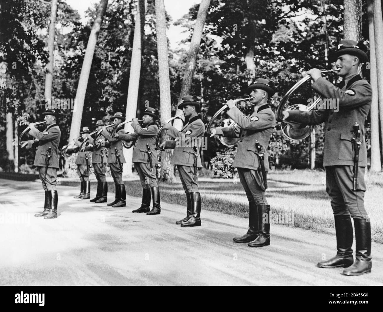 Forest officials blow par force horns on the occasion of the arrival of Italo Balbo to visit Hermann Goering at his hunting lodge Karinhall. Stock Photo