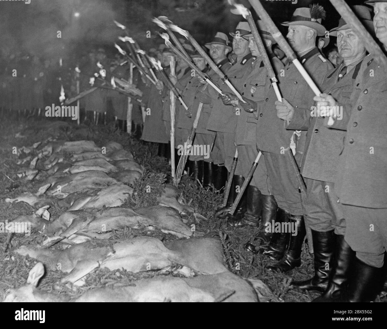 forest-officials-with-torches-along-the-route-during-a-visit-of-hermann-goering-near-braunschweig-who-donated-a-castle-to-the-winterhilfswerk-2BX55G2.jpg