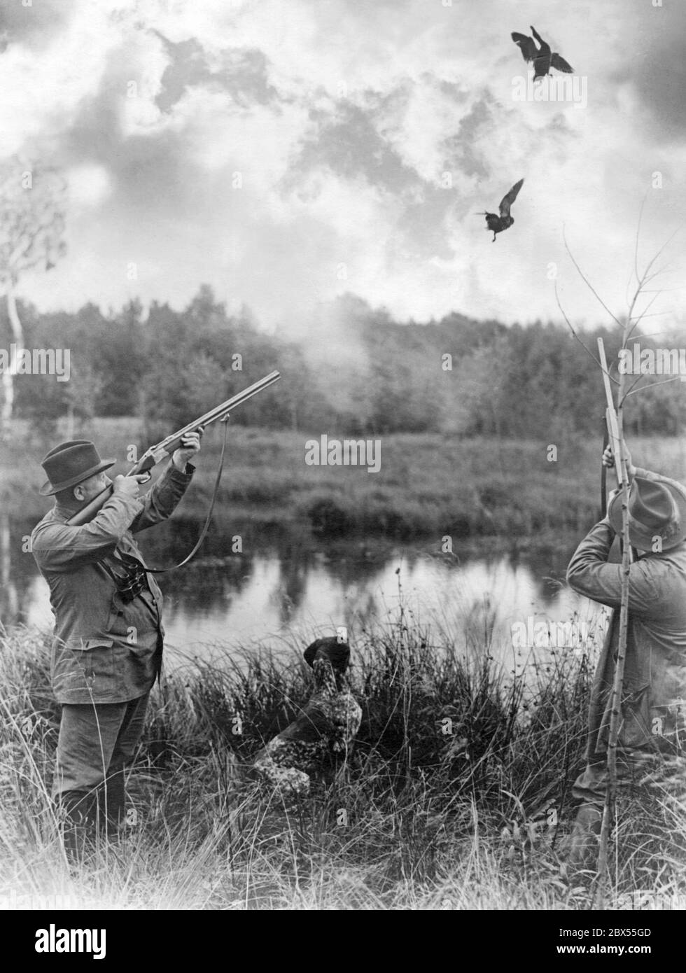 Hunters shooting ducks. Stock Photo