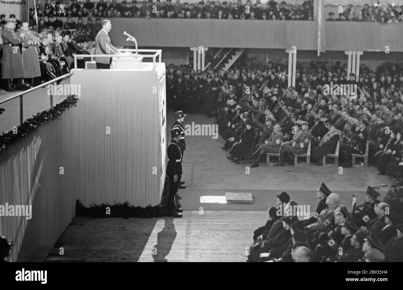 Adolf Hitler gives a speech at the Nordwestbahnhalle in Vienna. After the annexation of Austria to the German Reich, the Day of the Greater German Reich is being celebrated. Stock Photo
