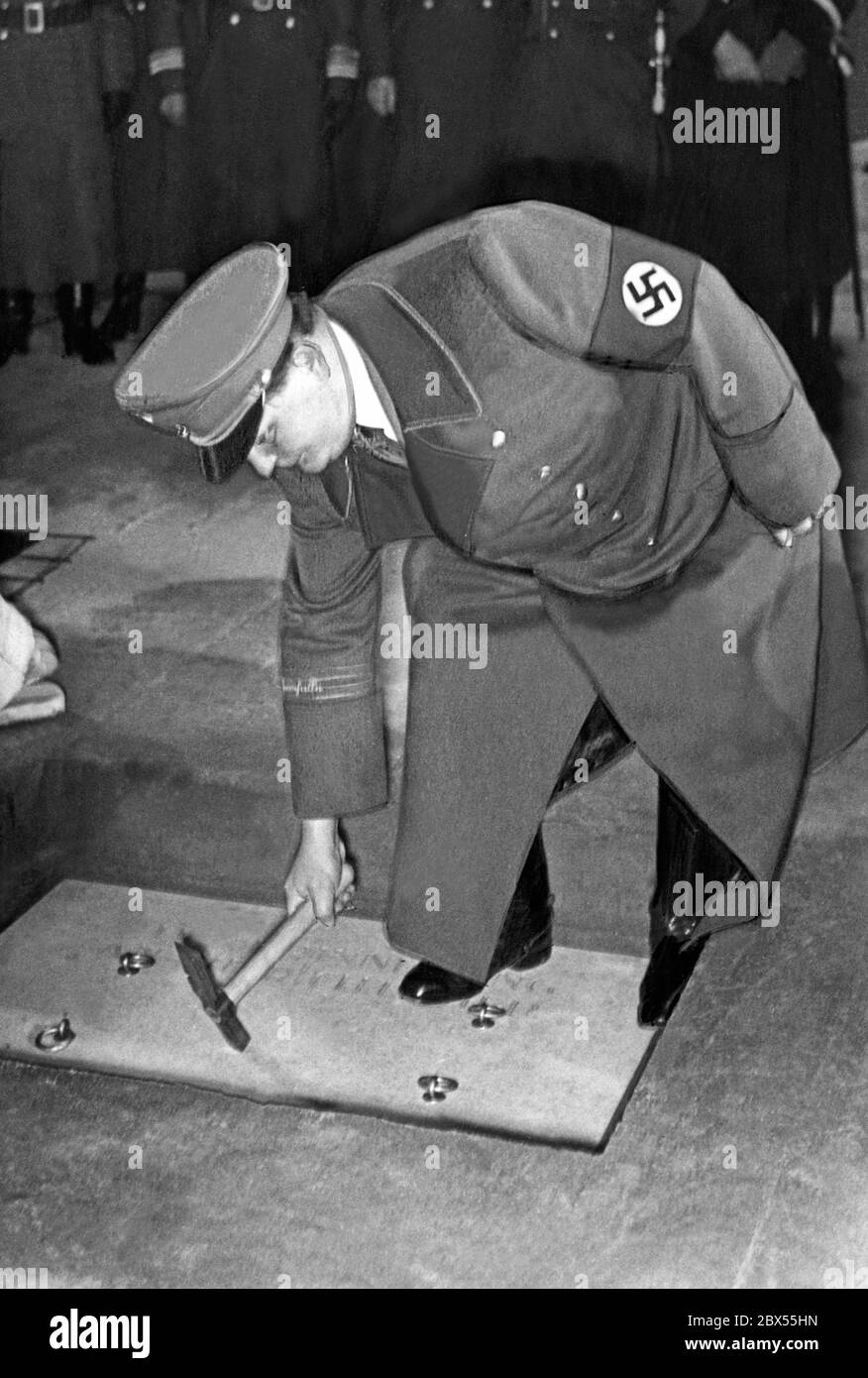 Topping out ceremony at the Tempelhof Airport. Here, Hermann Goering hits three times a box in the terminal building, in which a gift certificate has been placed. Stock Photo