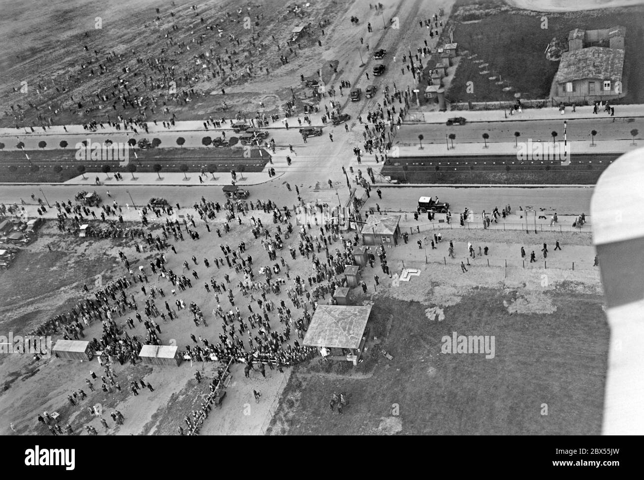 Aerial photo of a crowd of people on Tempelhofer Feld taken by Junkers Luftbild. Stock Photo