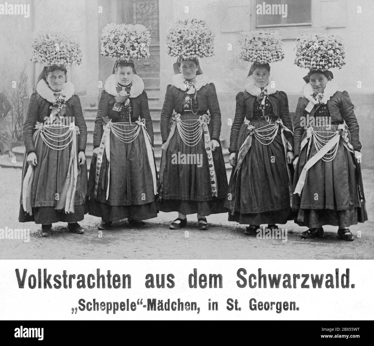 Young women from Sankt Georgen in the Black Forest wear traditional folk costumes and large bridal crowns (Schaeppel). Stock Photo
