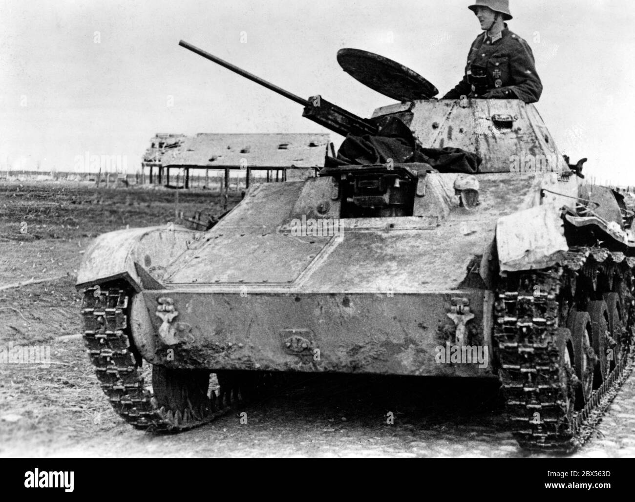 A soldier of the Wehrmacht on a captured T-60 tank. During the encirclement battle of Kholm the 'Kampfgruppe Scherer' successfully defended the city for 105 days. (A photo of the Propaganda Company (PK) by war correspondent Richard Muck, who flew into the pocket at the beginning of March). Stock Photo