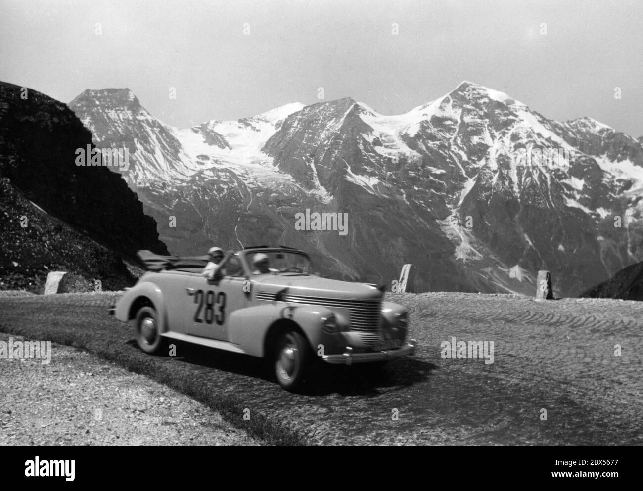 Participants of the Internationale Deutsche Alpenfahrt (International German Alpine Rally) in an Opel. Stock Photo