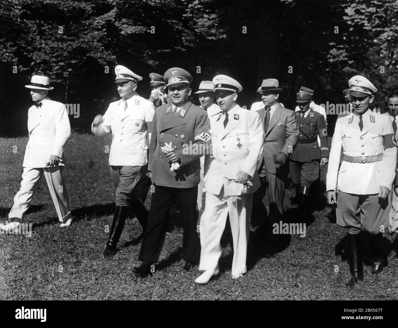 Arrival of Adolf Wagner (centre left), Gauleiter of Munich-Upper Bavaria, and Reich Press Officer Otto Dietrich (centre right) at Nymphenburg Palace in Munich. Dietrich had invited the domestic and foreign press to a gala reception there. Stock Photo