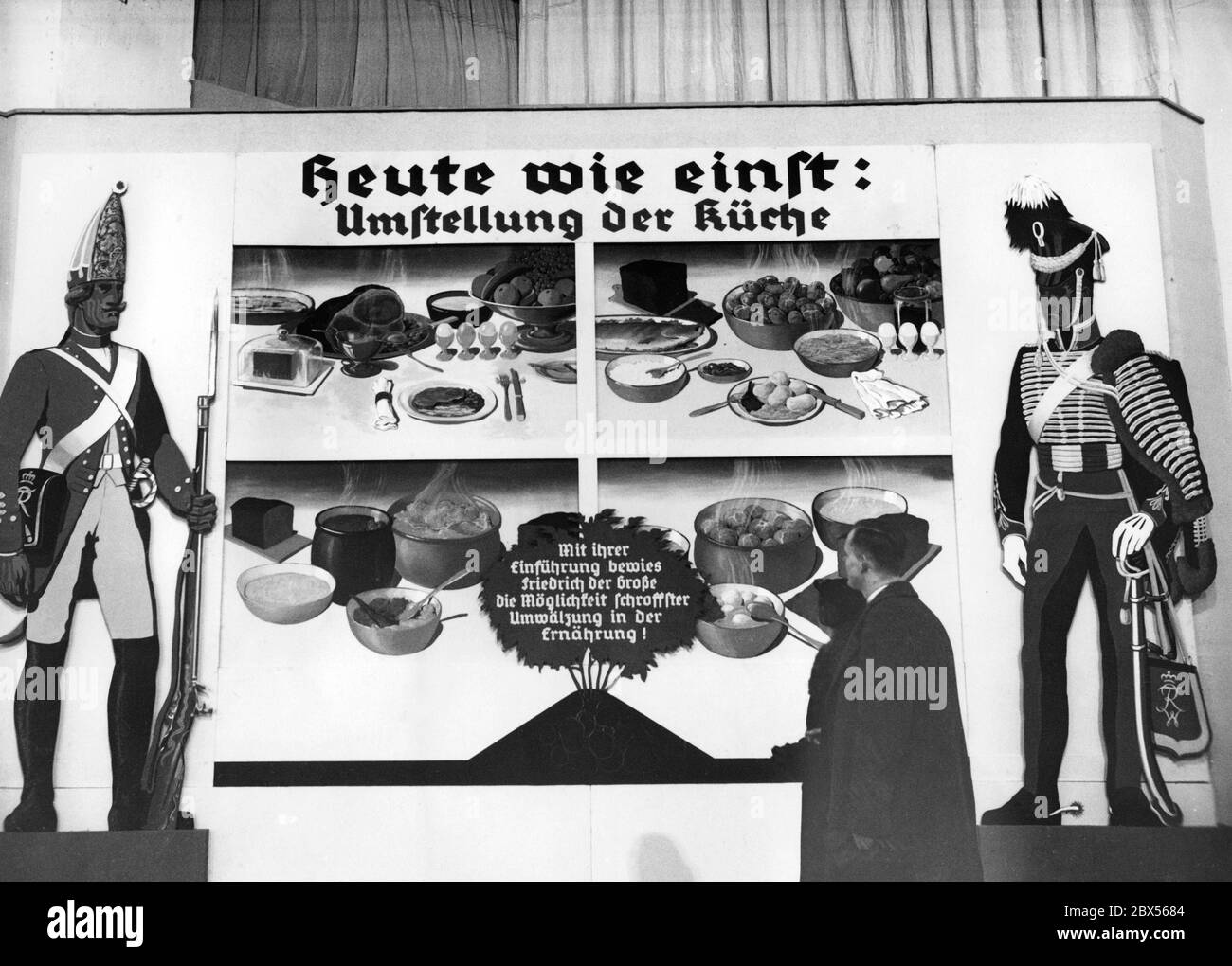 Information board on the rearrangement of the kitchen under Frederick the Great of Prussia at the international fair "Green Week Berlin". The board "Today as in the old days: rearrangement of the kitchen" draws a traditional line between the thriftiness of the food used during the reign of Frederick I and the Third Reich. " By introducing it, Frederick the Great proved the possibility of a radical change in nutrition!". Stock Photo
