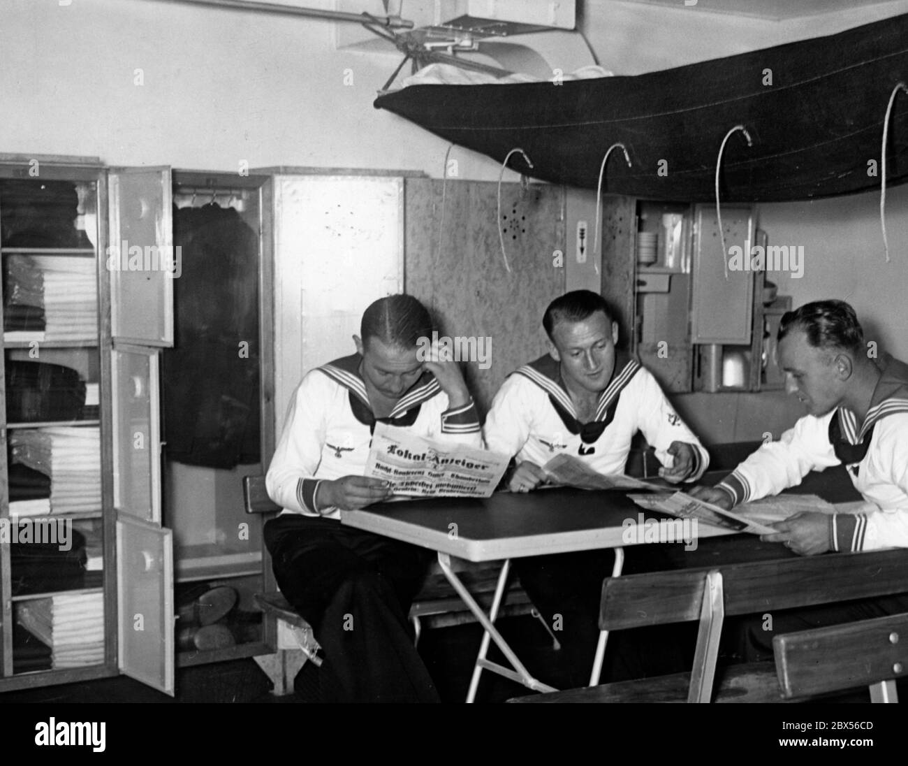 At the exhibition 'Gesundes Leben - Frohes Schaffen' ( Healthy Life - Glad Work) is displayed a crew room in a warship where sailors can read newspapers like the Lokal-Anzeiger. Stock Photo