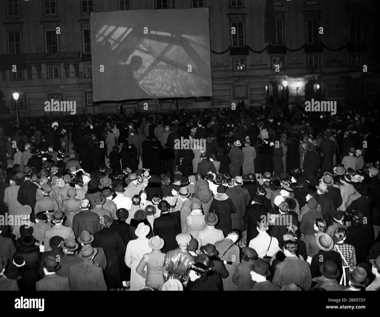 On the day of the annexation of Austria to the German Reich, propaganda films are screened at Vienna's Heldenplatz. At the same time the election results are being announced. Stock Photo