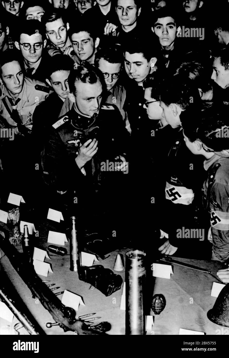 A picture of an event of the Hitler Youth at the Urania in Vienna, where young officers tell about their experiences during the Polish campaign to a crowd of Hitler Youth and present war equipment. Stock Photo