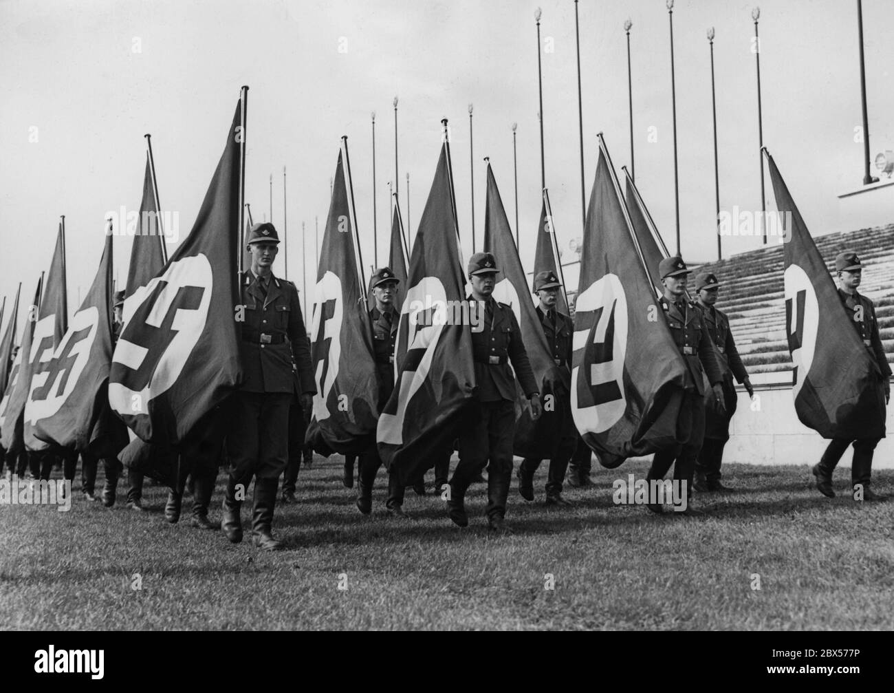 Flag wavers of the Reich Labor Service are rehearsing their roll call on the Zeppelin Field in Nuremberg in the days before the Reich Party Congress. Stock Photo