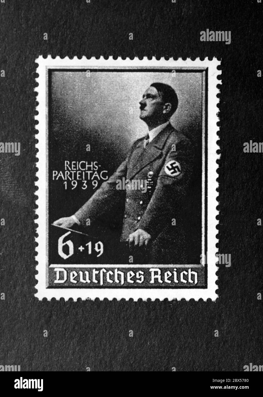 The postage stamp issued by the German Reichspost on the occasion of the Reich Party Congress of Peace shows a portrait of Adolf Hitler. The stamp is sold for 6 Pfennig plus a surcharge of 19 Rpf. for Adolf Hitler's cultural fund. Stock Photo