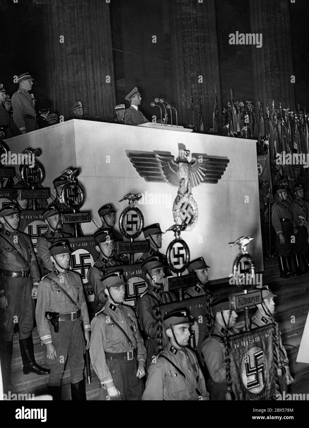 Reich Minister Dr. Goebbels during his speech at a mass rally in the Berlin Lustgarten. In front of the lectern are SA men with their standards. Stock Photo