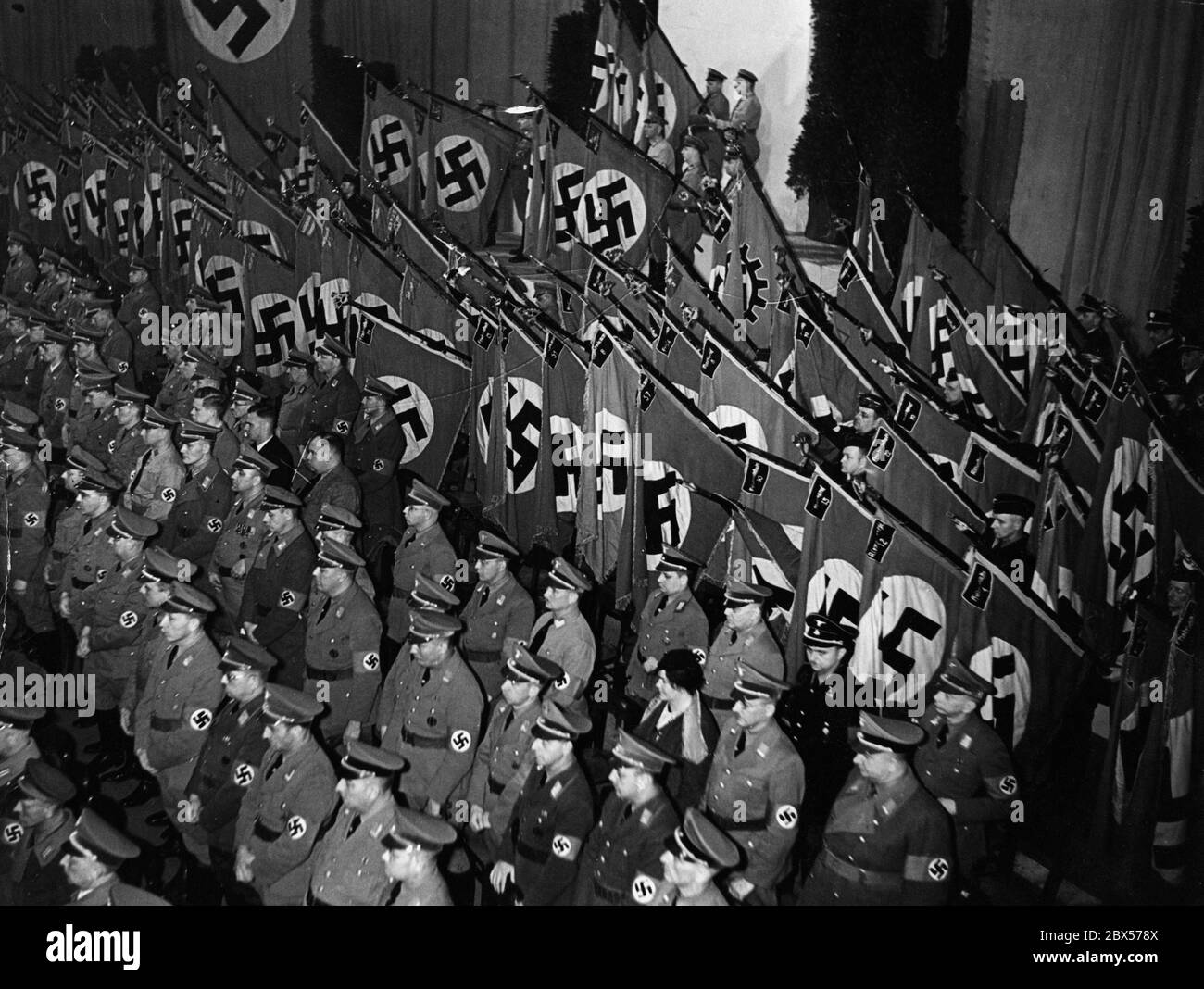 On the occasion of Adolf Hitler's birthday, political leaders are sworn in at the Sportpalast in Berlin. The flags are lowered in memory of the victims of the movement. Stock Photo