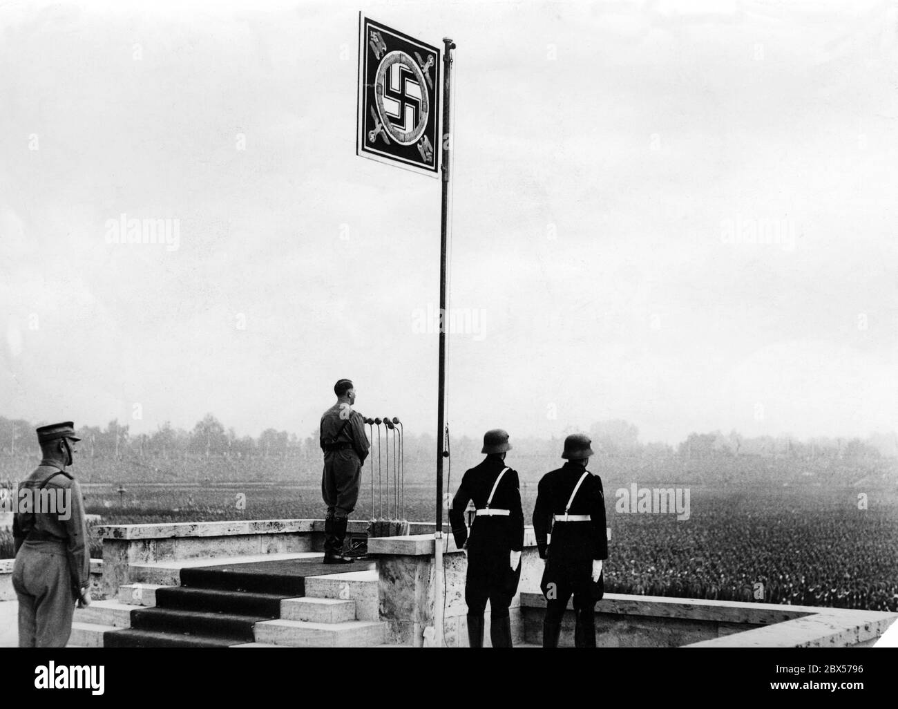 Adolf Hitler gives a speech at the grand roll call of the SA, SS, NSKK and NSFK in Nuremberg's Luitpold Arena. Behind him is Viktor Lutze, on the right two men of the SS. Stock Photo