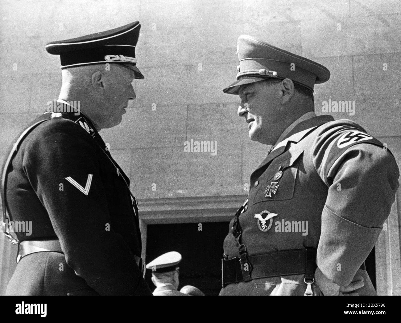 Hermann Goering (right) talking to State Secretary Hans Heinrich Lammers in front of the Luitpoldhalle at the opening of the Nuremberg Rally. Stock Photo