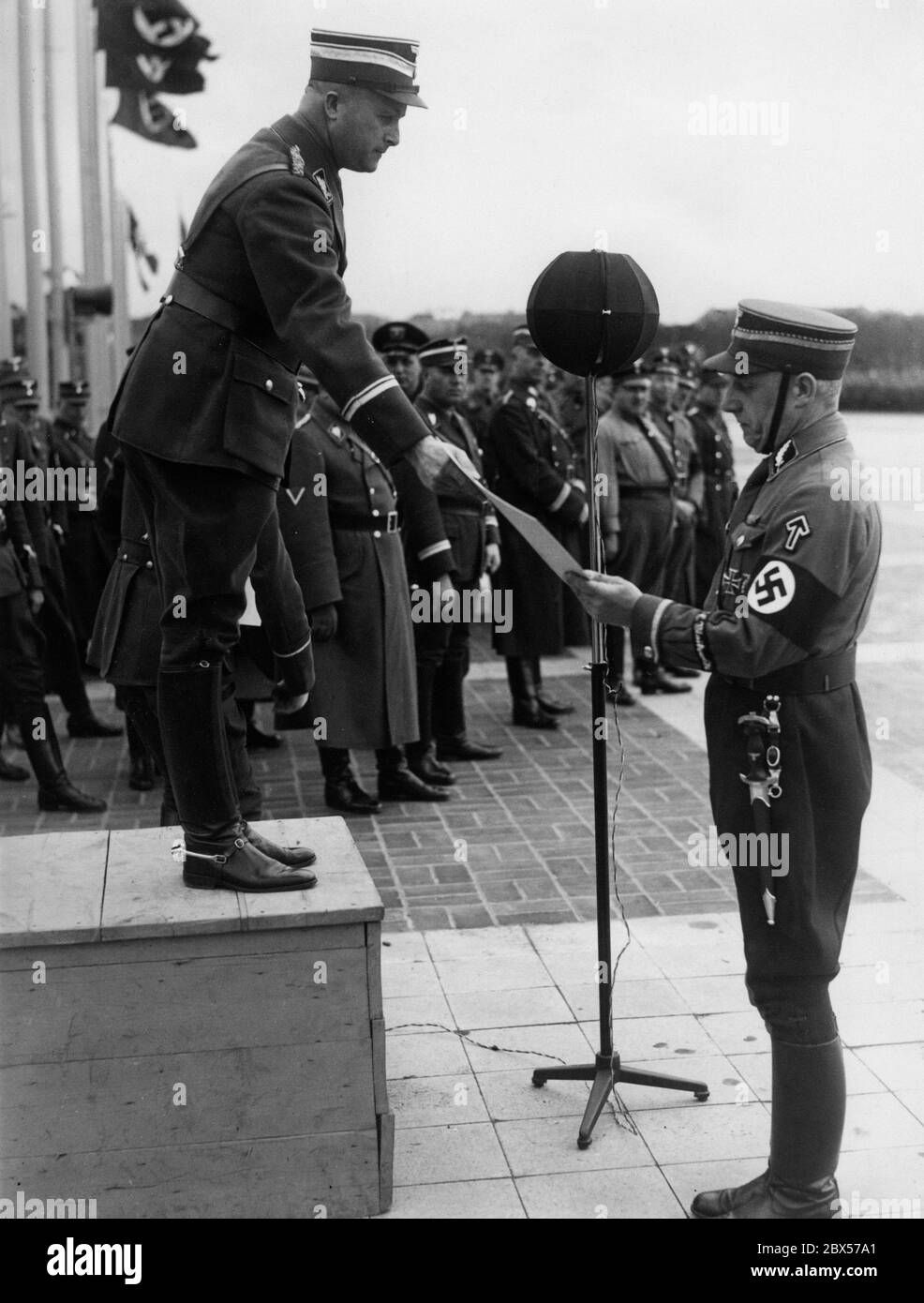 SA Obergruppenfuehrer Dietrich von Jagow (l) sends off the Standartenfuehrer of the Standarte 1 Erich Ernst(r) at the Olympic Park in Berlin. Ernst is presented with a picture. Stock Photo