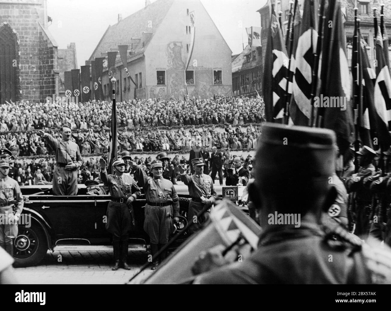 During the Reich Party Congress of Labor, Adolf Hitler takes the salute of  the Nazi formations in his Mercedes on Nuremberg's main market square, the  so-called Adolf-Hitler-Platz. In front of the car,