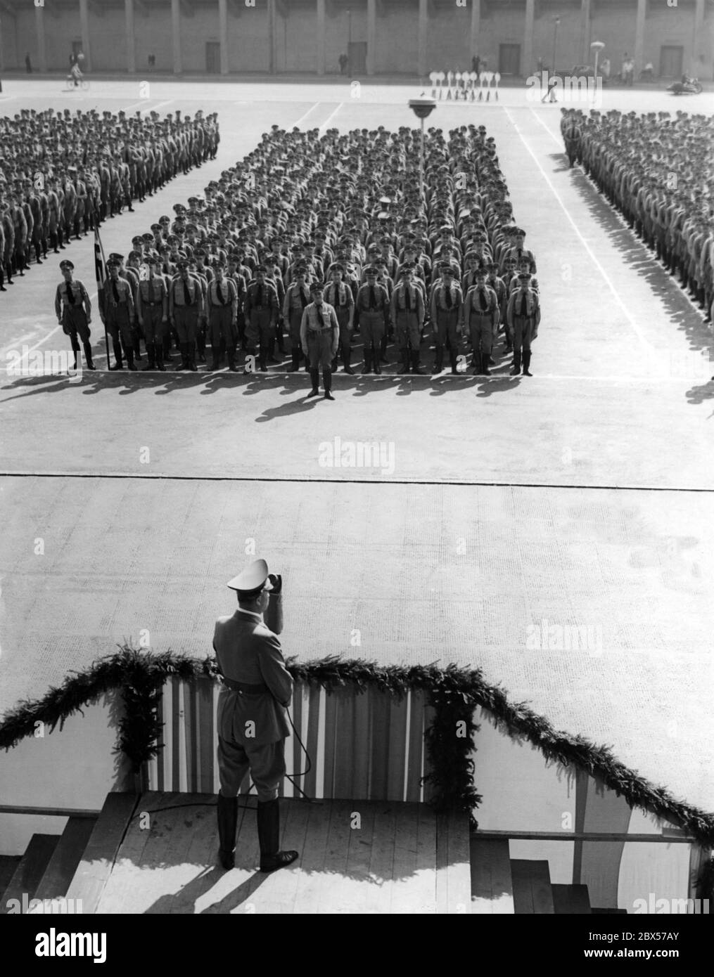 Artur Goerlitzer, deputy Gauleiter, gives a speech to the Nuernbergfahrer (10,000 political leaders of the Gau Berlin who will participate in the Nuremberg Rally) gathered in front of the Deutschlandhalle in Berlin. Stock Photo