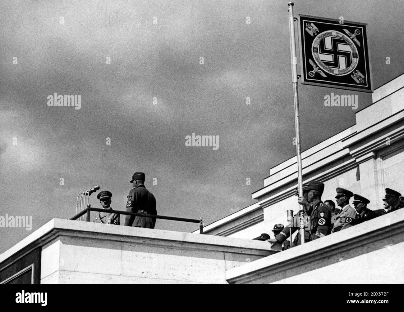 Konstantin Hierl reports to Adolf Hitler on the Zeppelin grandstand that approximately 38000 men and women of the Reich Labor Service got into position. On the right, Wilhelm Frick. Stock Photo