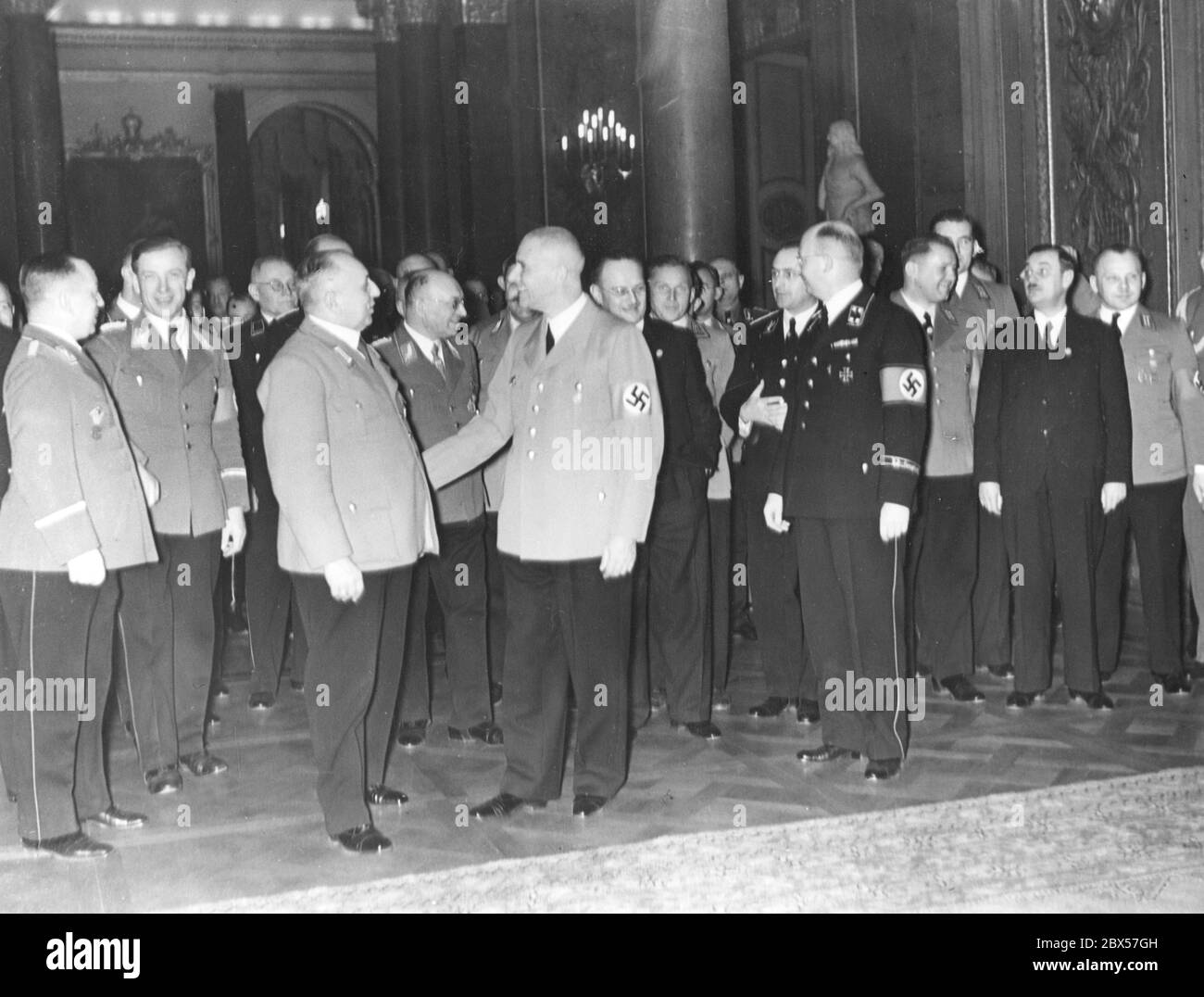 After the session of the Reichstag in the Berlin Kroll Opera House on February 20, 1938, the deputies arrive in the White Hall of the City Palace. 1st row, 3rd from left Robert Ley, opposite to him Wilhelm Frick, far right Walther Funk. Stock Photo