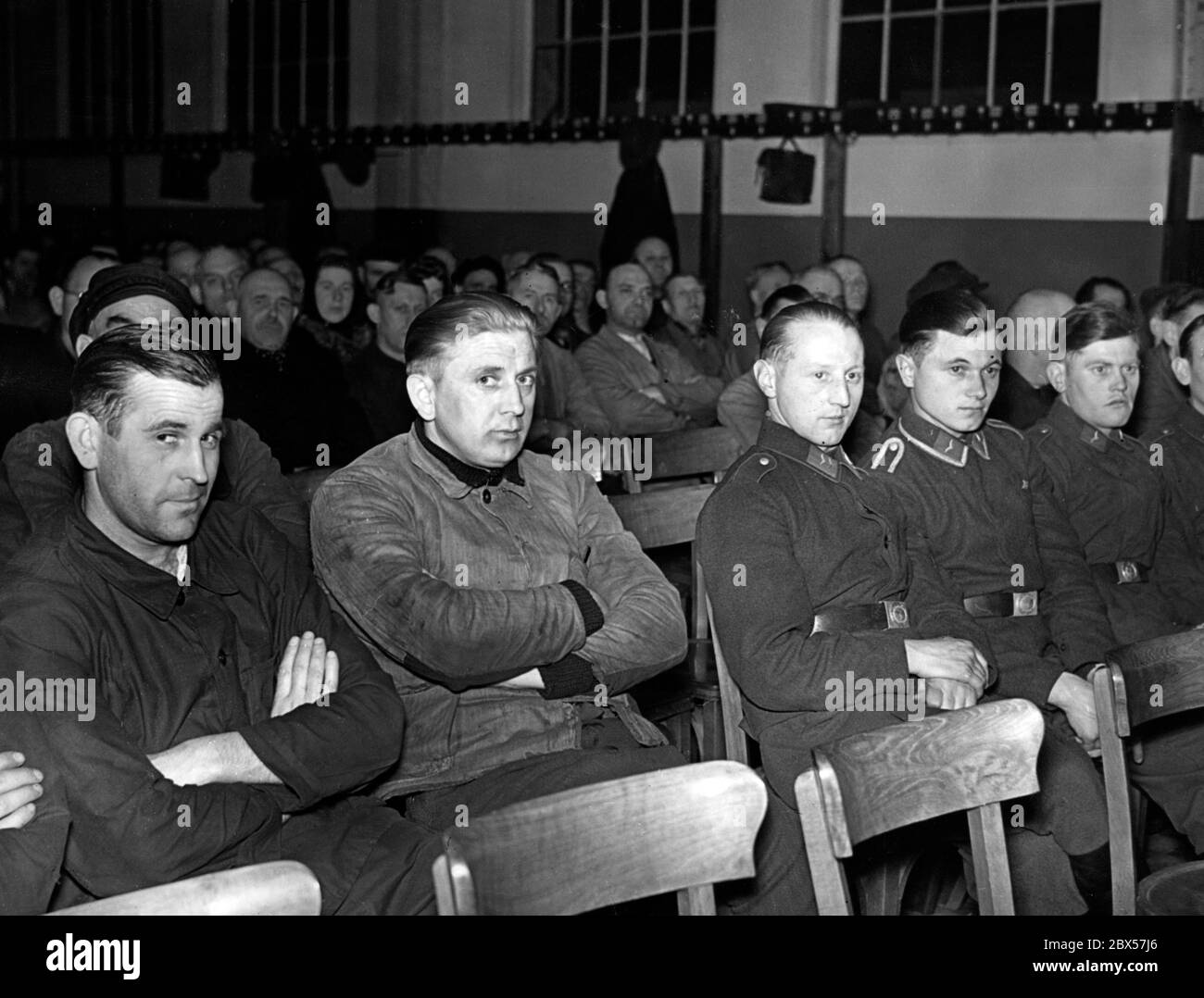 Soldiers and workers of the Alkett armaments factory in Berlin Borsingwalde follow a lecture on naval warfare. Stock Photo