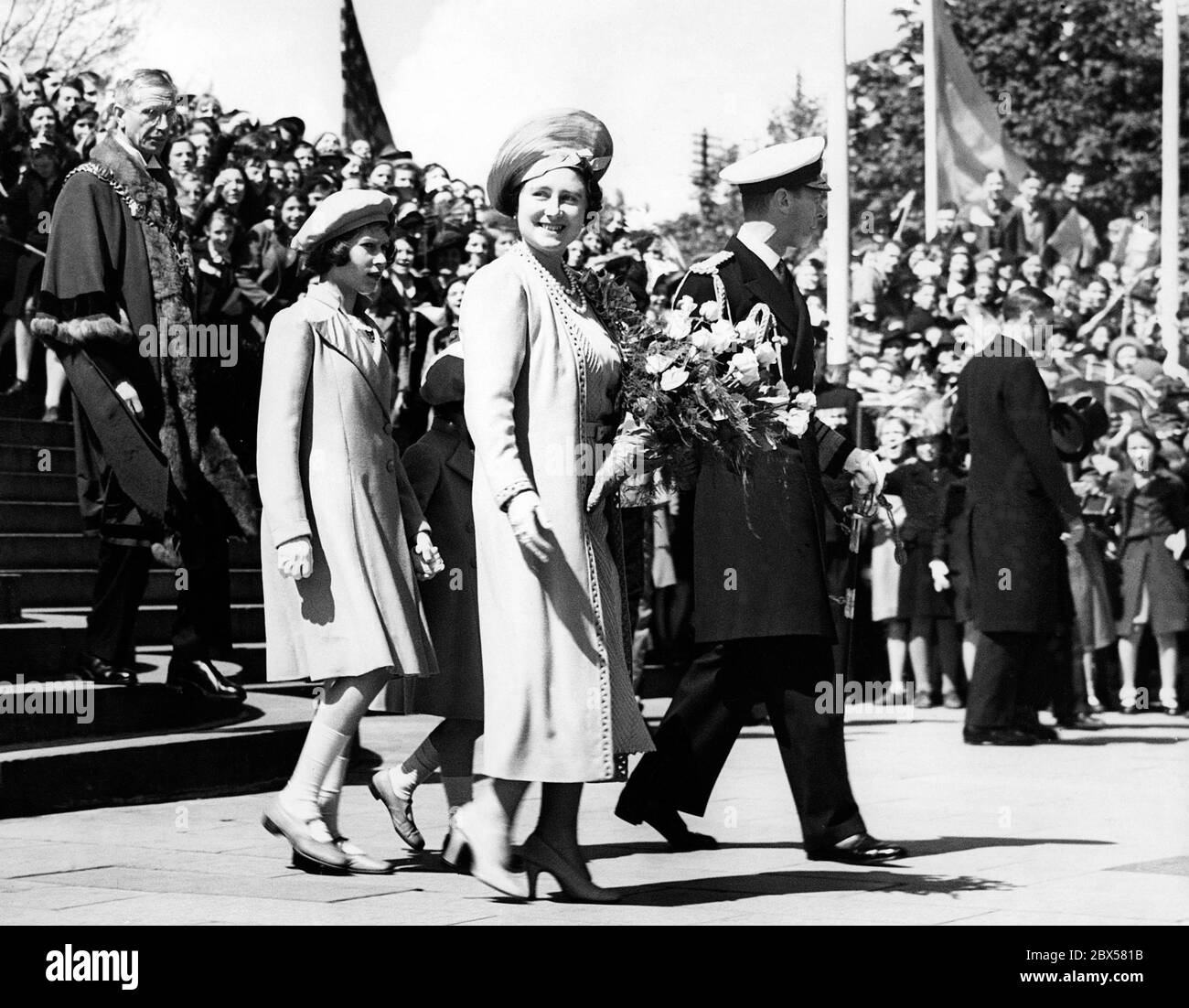 Elizabeth II (left) and Margaret Rose ( hidden) at the departure of their parents, Queen Elizabeth (centre) and King George VI (right), to Canada and USA. King George VI receives 'the Keys of Portsmouth'. Stock Photo