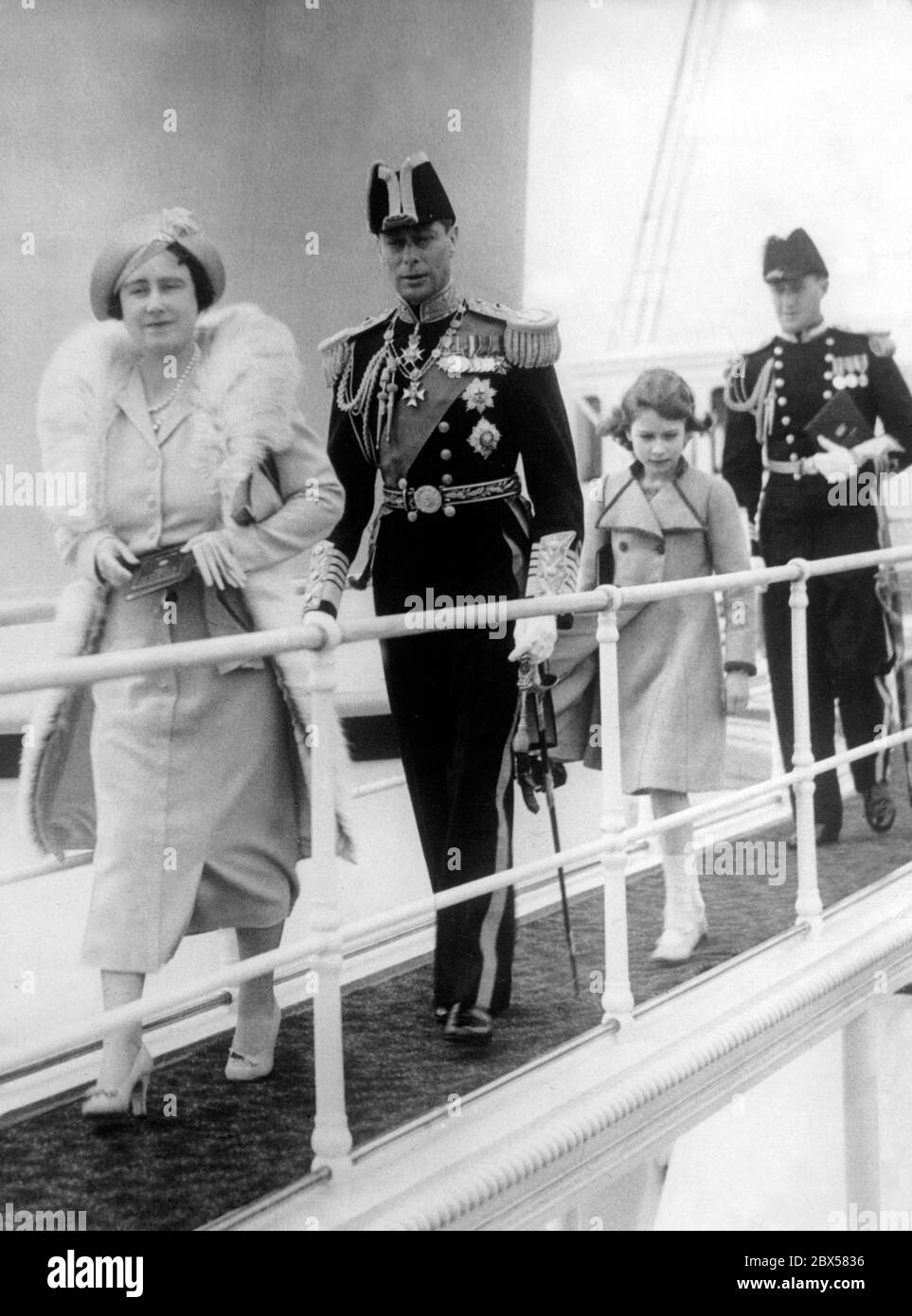 From left to right: Queen Elizabeth, King George VI: and Crown Princess Elizabeth II on board the royal yacht 'Victoria and Albert' during the Coronation Review of the British and Merchant Navy at Spithead. More than 300 ships took part in the Fleet Parade, 17 of them were foreign warships. Stock Photo